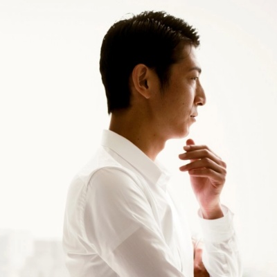 HR professional standing at an office window looking outside.