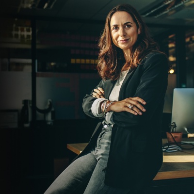 businesswoman leaning on a desk in an office