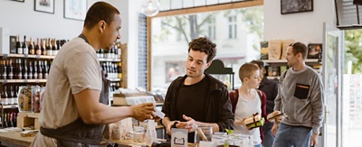 Cashier working with a customer at a small retail shop. 