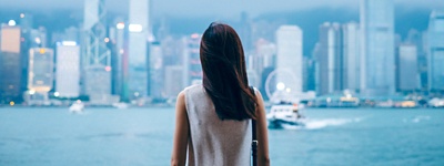 Person looking out at a cityscape.