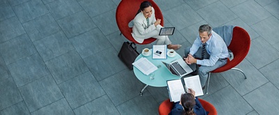Aerial view of professional colleagues collaborating around a coffee table