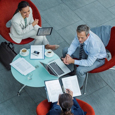 Aerial view of professional colleagues collaborating around a coffee table