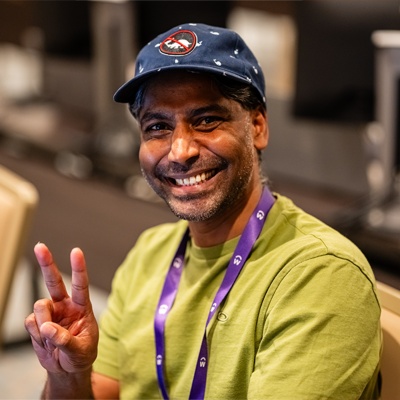 man at Workday DevCon giving peace sign
