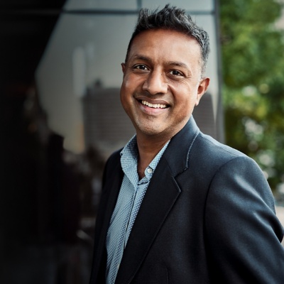 man standing outside smiling at camera