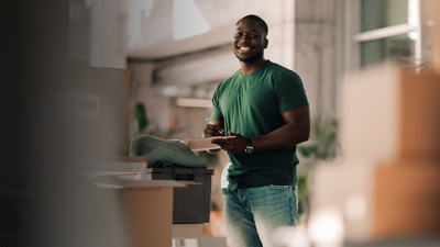 man holding clipboard and pen smiling