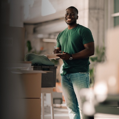 man holding clipboard and pen smiling
