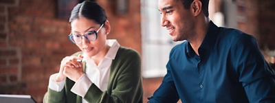 due persone che guardano lo schermo di un laptop in ufficio
