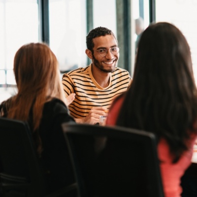 people talking at conference table in office