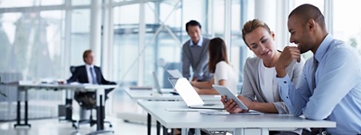 Two office workers collaborating in a conference room.