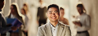 Businessman with crossed arms smiling at camera