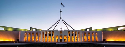 Photo of parliament house in Canberra at sunrise.