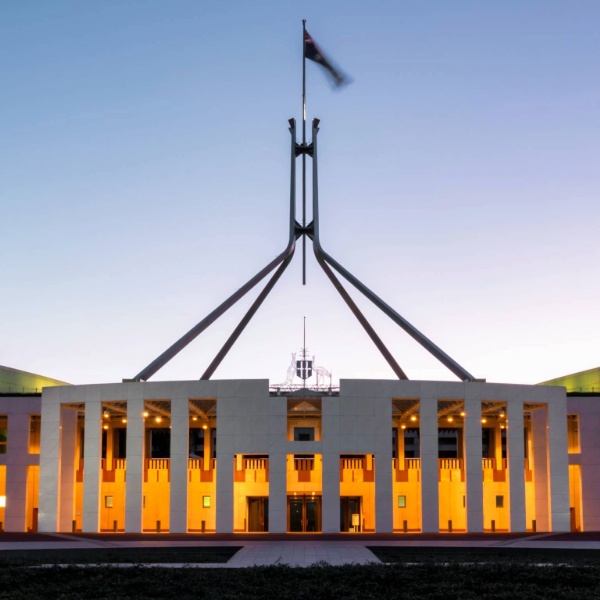 Photo of parliament house in Canberra at sunrise.