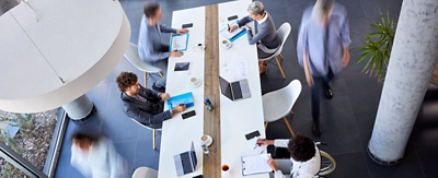 Aerial view of a group of professional colleagues working in a co-working or open concept workspace.