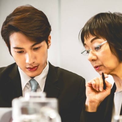 Two colleagues working on laptop together