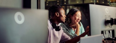 Two colleagues looking at computer screen