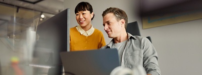 Colleagues in office looking at computer