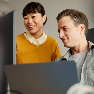 Colleagues in office looking at computer