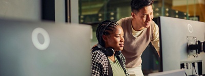 Alt text: Colleagues looking at computer in office