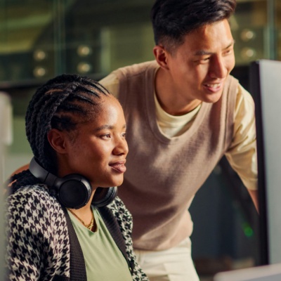 Colleagues looking at computer in office