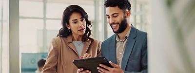 Coworkers conversing looking at tablet