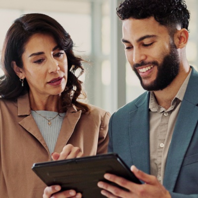 Coworkers conversing looking at tablet