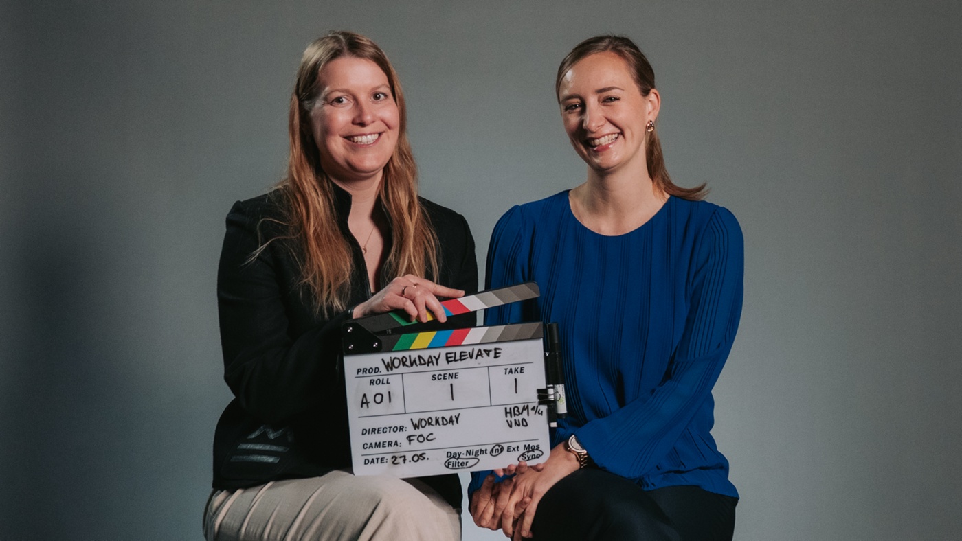 Image of two woman holding a clapperboard