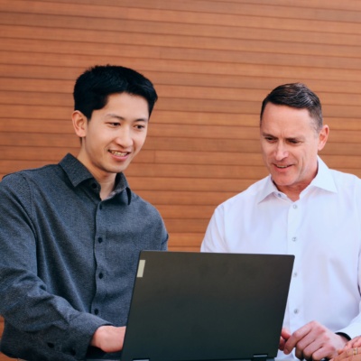 Three people working on laptop together