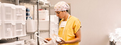 Doctor in scrubs looking at medical tools