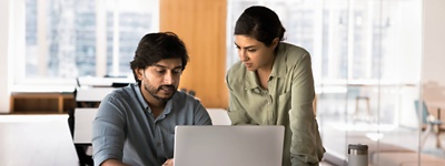 Two people working together on laptop