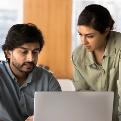 Two people working together on laptop