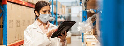 Female worker selecting parts in a factory