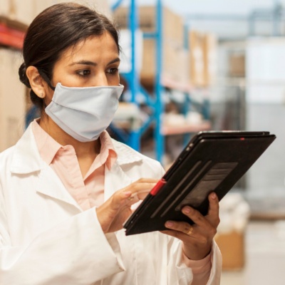 Female worker selecting parts in a factory