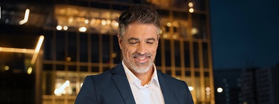 Middle aged man wearing suit using iPad