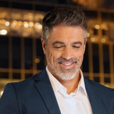 Middle aged man wearing suit using iPad