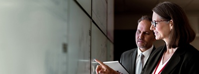 Two colleagues working on laptop together