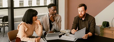 Group of coworkers at table looking at document