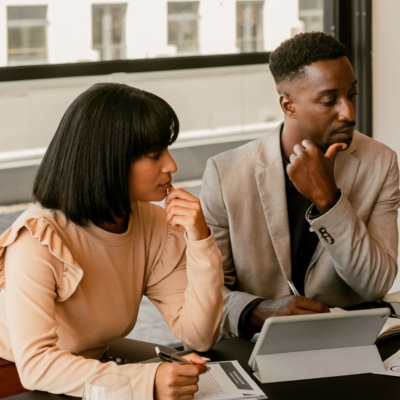 Group of coworkers at table looking at document