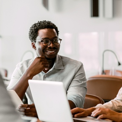 Group of coworkers in meeting woman on laptop
