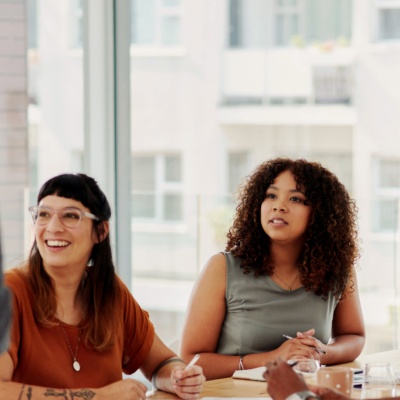 Group of coworkers sitting at table in meeting
