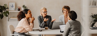 Group of employees talking at table
