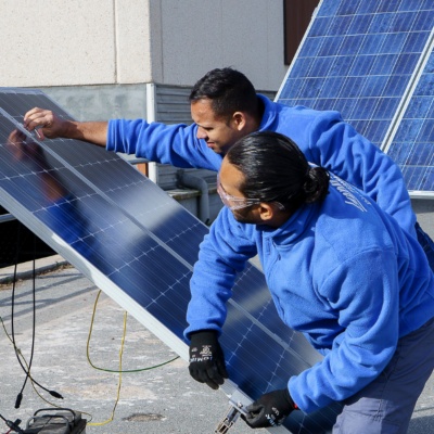 Workers installing solar panels