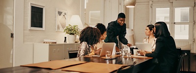 Group of woman colleagues sitting at table
