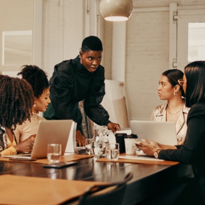 Group of woman colleagues sitting at table
