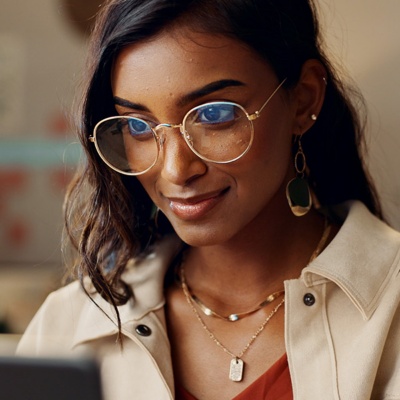 A woman looking at a laptop screen in an office space