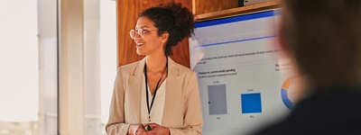 Woman presents infront of screen 