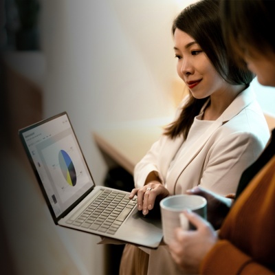 Two women look at a business plan on a laptop