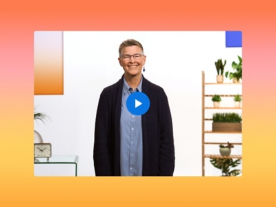 A smiling Tammy Snow stands in a bright, modern office setting with a play button overlay. They wear a blue button-down shirt and a navy cardigan, set against a vibrant orange and yellow gradient border.