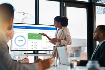 Image of a CFO presenting to colleagues in a boardroom