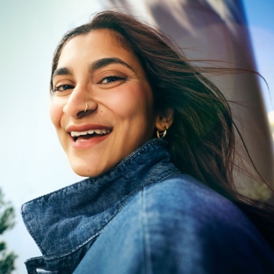 Woman smiling outside of an office building.