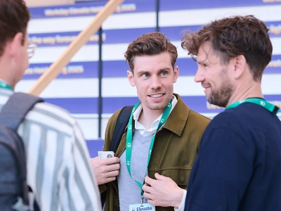 Three Workday event attendees chatting.